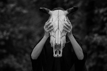 Victim with skull of the animal instead of head. Photo stylized as shooting on an old camera, with...