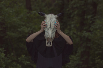 Victim with skull of the animal instead of head. Photo stylized as shooting on an old camera, with...