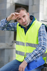 plasterer repairman foreman takes off helmet or hard hat