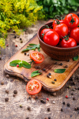 Cooking background. Fresh vegetables and peppers on wooden background. Ripe tomatoes and herbs
