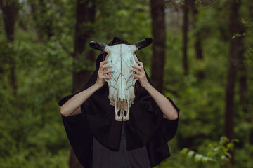 Victim with skull of the animal instead of head. Photo stylized as shooting on an old camera, with...