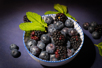 Blueberries and blackberries in a bowl. Close-up