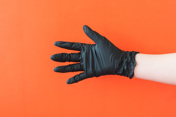 Hands with black gloves on blue background.