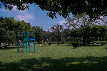childens playground park in a sunny daylight with blue and cloudy sky at raiganj, bengal, malda.
