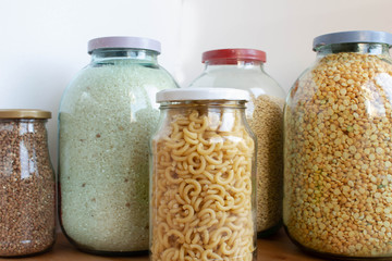 various cereals in glass jars isolated on a white background. Close up