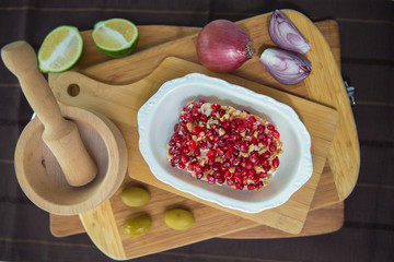 Grated boiled beetroot with garlic and mayonnaise. Panamanian party salad made with potatoes, beets, eggs,onions and mayonnaise . wooden board , mortar and pestle . Salad with mayonnaise and beet .