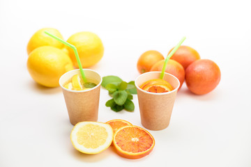 Two recyclable cardboard cups with natural and healthy lemonade and orangeade