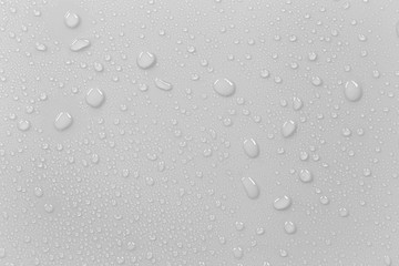 The concept of raindrops falling on a gray background Abstract wet white surface with bubbles on...