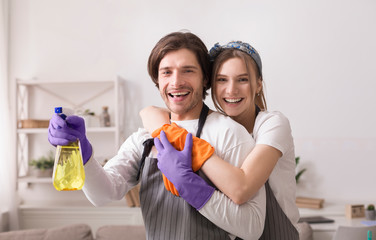 Happy Young Spouses Posing During Spring-Cleaning Apartment Together