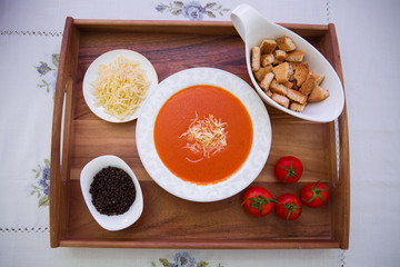Red lentil soup . Spaghetti white plate . Dry bread and pepper . Red tomatoes . Tomato Soup wooden tray .