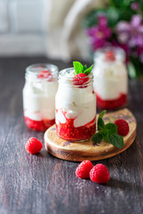 Fermented drink kefir, yogurt in a glass jar on a dark wooden background. Probiotic cold fermented dairy drink. Copy space