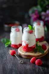 Fermented drink kefir, yogurt in a glass jar on a dark wooden background. Probiotic cold fermented dairy drink. Copy space