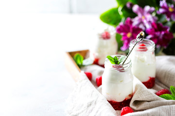 Fermented drink kefir, yogurt in a glass jar on a light background. Probiotic cold fermented dairy drink.