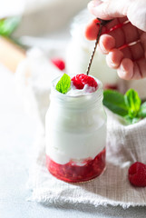 Fermented drink kefir, yogurt in a glass jar on a light background. Probiotic cold fermented dairy...