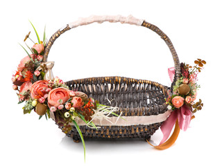 Beautiful flower arrangement on original brown wicker basket. Floral concept. Easter Basket. Spring colors.