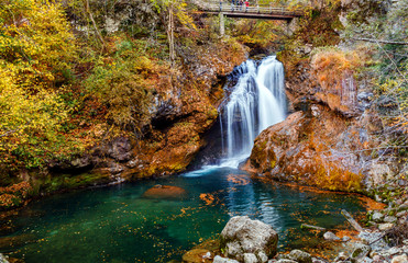 Wonderful Autumn landscape with Beautiful little waterfall in forest. Waterfall at Soteska vintgar,...