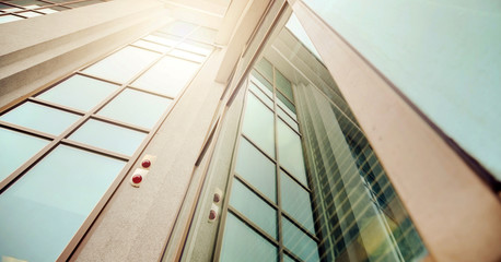 Obraz premium beautiful office building with large windows at bright spring sunlight in downtown