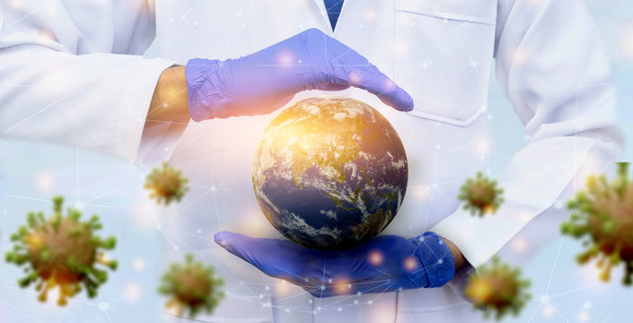 Globe earth in doctor's hand wearing glove to save from viruses.