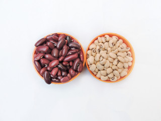 Red kidney beans and black eyed kidney beans in isolated white background. 