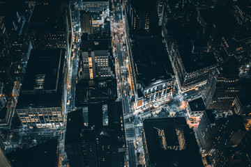 Aerial view of New York downtown building roofs. Bird's eye view from helicopter of cityscape metropolis infrastructure, traffic cars, yellow cabs moving on city streets and crossing district avenues © pipil7385