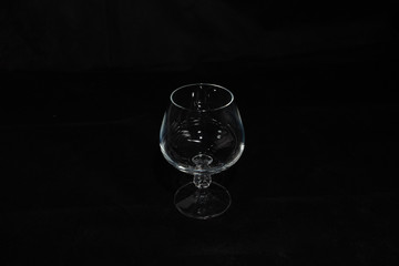 one crystal glass on a dark background,