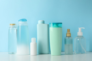 Blank bottles for cosmetics on blue background