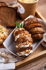 Street food. Lemon tea, salad, baked potatoes with meat, sauce and rosemary sausage rolls. Top view.