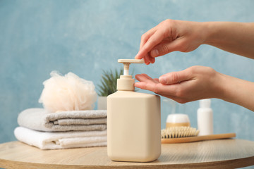 Female hands squeeze liquid soap. Personal hygiene concept