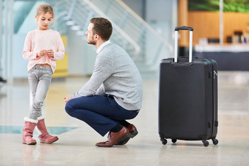 Father says goodbye to his daughter in the airport