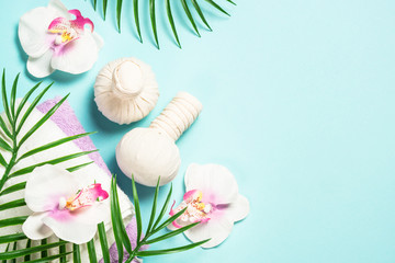 Spa herbal compressing balls on blue background.