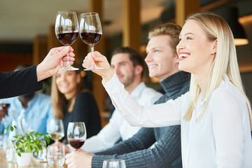 Young woman toasting with red wine