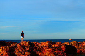 silhouette of a man standing on a rock