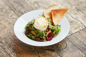 Fresh beetroot salad with Camembert and toast