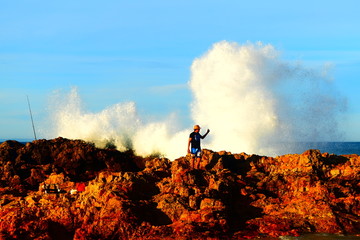 Splash of wave on the rocky beach