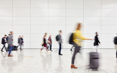 Anonymous people are walking through hall in the airport