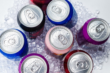 Group of aluminium cans in ice, cold drink.