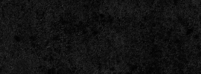 Black background of a texture of cement wall, stone and concrete, with some little moss - Dark stage background - Large panoramic format