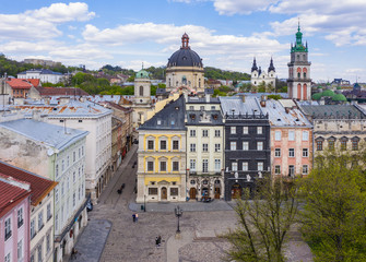 Obraz premium Aerial view on Market square, Dormition, Dominican and Carmelite Church in Lviv, Ukraine from drone