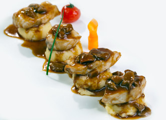 Pork fillet cooked and covered with dark sauce