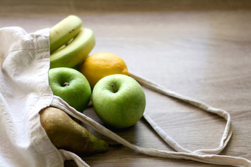 Various fruit in a canvas tote bag. Selective focus.