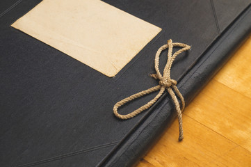 Vintage folder for paper with blank label. old folder for documents lies on a wooden table