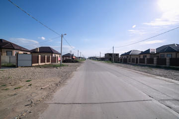 asvalified road with houses in one floor