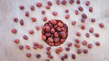 Top view close up, dried jujube in wooden basket for traditional Chinese herb ,copy space for your text.
