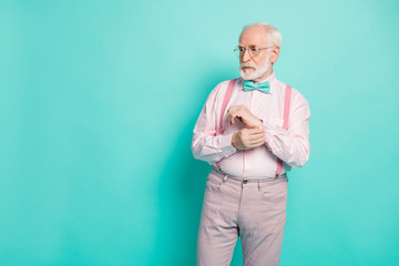 Photo of attractive serious hipster grandpa preparing senior meeting party buttoning sleeve look...