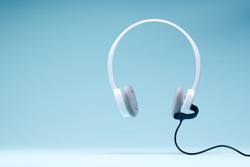 Headphones with microphone isolated on blank blue background