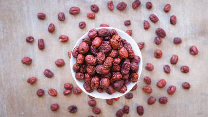 Top view close up, dried jujube in wooden basket for traditional Chinese herb ,copy space for your text.