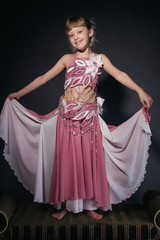 A little girl dressed as an belly dancer