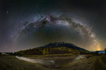 Milky way over the Piatra Craiului mountains and river from Romania