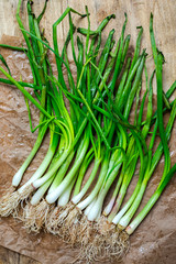 Fresh red and white onions on wood background