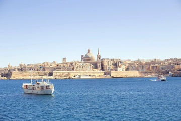 an amazing panoramic view of an ancient capital city Valletta in Malta   with a boat in the sea